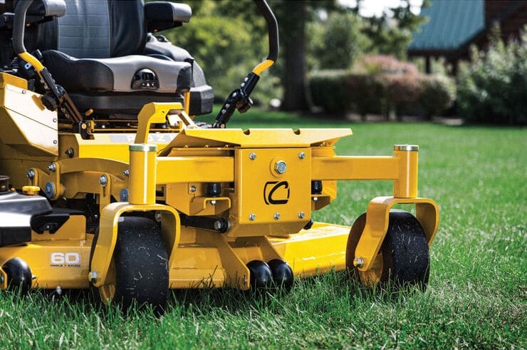 A yellow Cub Cadet® Commercial Zero-Turn Mower PRO Z 960 L parked on lush green grass, ready for action.